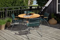 an outdoor table and chairs on a deck