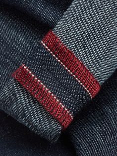 closeup of the red and white stripe on a blue suit