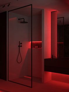 a bathroom with red light coming in from the shower