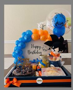 a birthday gift box with balloons, cake and candy in the shape of mickey mouse