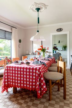 a dining room table with red and white checkered cloth