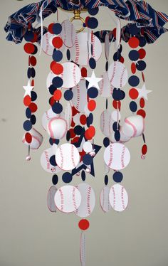 a mobile with baseballs and stars hanging from it's sides in red, white, and blue colors