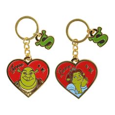 two heart shaped key chains with the characters from shrap and she's got it