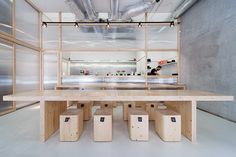 an empty room with several stools and tables in front of the counter area,