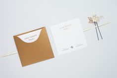 the wedding stationery is laid out on top of each other, along with some flowers