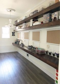 an empty room with wooden floors and shelves