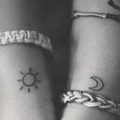 two wrist tattoos with the sun and moon on them