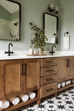 a bathroom with two sinks and mirrors on the wall next to a tiled floor that has black and white tiles