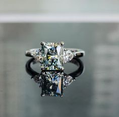 an engagement ring with three stone diamonds on it