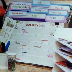 a desk with calendars and pens on it