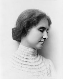 a black and white photo of a woman wearing a collared shirt with her eyes closed