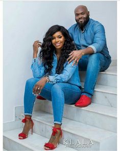 a man and woman are sitting on the stairs together, posing for an instagram