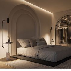 a large bed sitting in a bedroom next to a mirror on the side of a wall