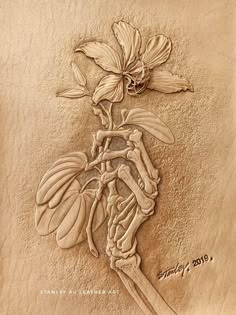 a drawing of a flower on the sand