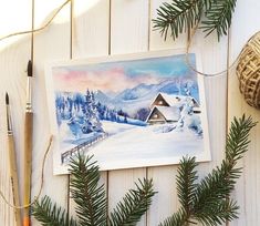 a watercolor painting of a winter scene with pine branches and yarn on the table