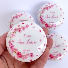 three white buttons with pink flowers on them and the words, i love you in cursive writing