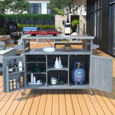 an outdoor kitchen is shown on the deck