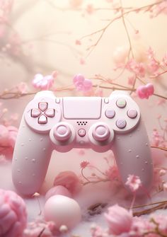 a close up of a video game controller surrounded by pink flowers and branches in the background