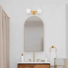 a bathroom with a sink, mirror and towel rack