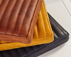 the seat cushion is yellow and brown with black stitching on it's sides