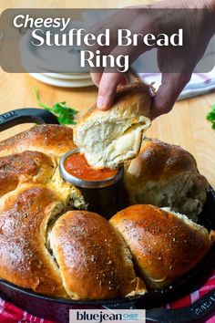 a person dipping some bread into a bowl with sauce on it and the words, cheesy stuffed bread ring