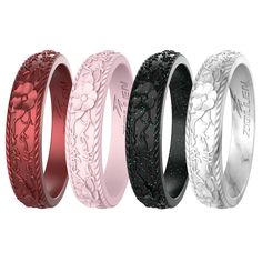 four different colored wedding bands with flowers on the sides and black, white, pink, red