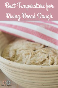 a bowl filled with bread sitting on top of a table next to a pink and white striped