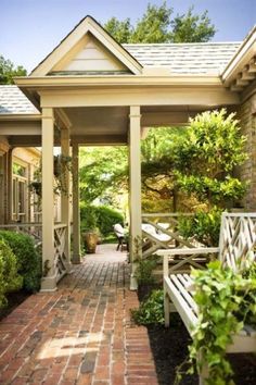 a brick walkway leads to a covered porch