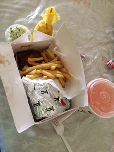 a box filled with french fries and other food