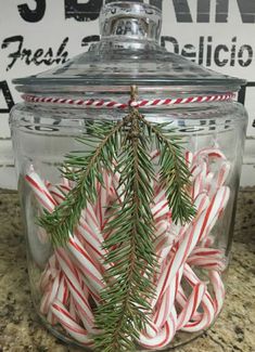 some candy canes are in a glass jar