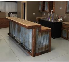 a kitchen with an island made out of metal and wood