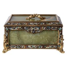 an ornately decorated box with gold trimmings and green marble inlaying