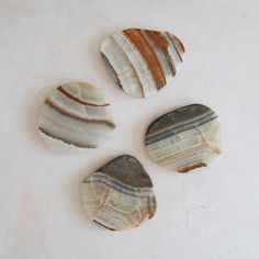 four different types of rocks on a white surface