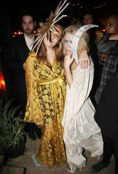 two women dressed up as witches pose for the camera