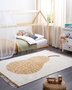 a child's bedroom with a bed, dresser and rug