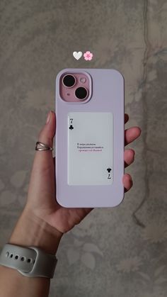 a person holding a pink phone case in their hand