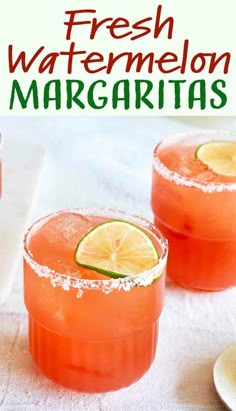 two glasses filled with watermelon margaritas sitting on top of a white table