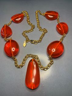 WONDERFUL DESIGNER KENNETH jay lane Long Gold Orange Large Resin Drops Necklace Avantgarde Runway Glamour Statement Couture Signed Vintage Featuring a gorgeous long necklace by Kenneth jay lane, Large resin orange drops in between a gold chain.Very striking and yet catching. Signed on Tag, comes in pouch and original box. Kenneth Jay Lane was one of my favourite customs jewellery designers, Many famous people were his clients, from Jacky Onassis to Madonna, Princess Diana to other Royals!! This Drops Necklace, Lana Lang, Jackie Onassis, Brass Necklace, Gold Orange, Custom Jewelry Design, Kenneth Jay Lane, Orange Gold, Drop Necklace