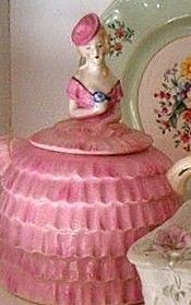 a pink tea pot sitting on top of a table next to a plate and bowl