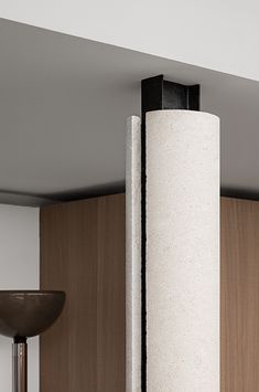 a tall white pillar sitting in the middle of a room