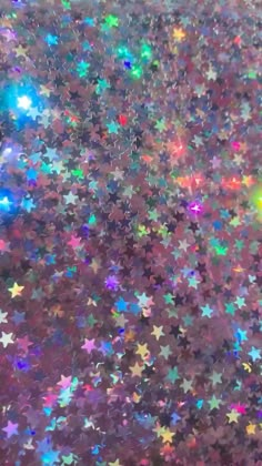 an image of many stars in the sky that are multicolored and glittery