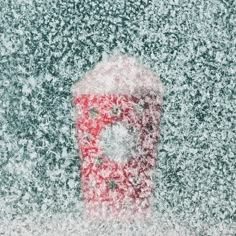 a red and white fire hydrant covered in snow