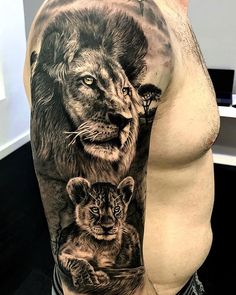 a man with a lion and cub tattoo on his arm