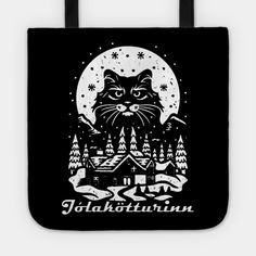 a black and white tote bag with an image of a cat in the woods