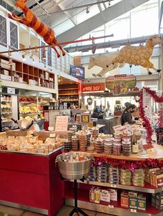 a store filled with lots of different types of food and decorations hanging from the ceiling