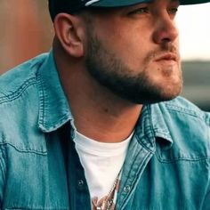 a close up of a person wearing a hat and looking off to the side with a serious look on his face