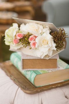 an arrangement of flowers on top of a book