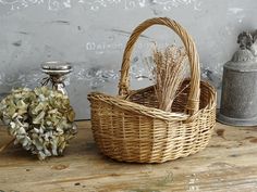 a wicker basket sitting on top of a wooden table next to a salt shaker