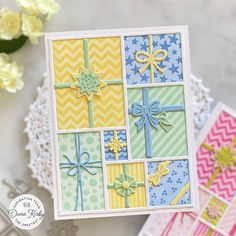 a close up of a card with different designs on it and flowers in the background