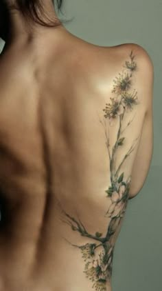 the back of a woman's body with flowers on it